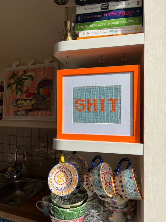 ‘SHIT’ framed tapestry